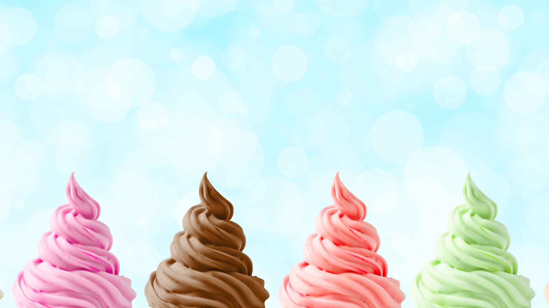 Four colorful ice cream cones against a light blue sky background