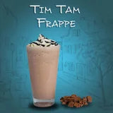Glass of Tim Tam Frappe with whipped cream and cookies on a blue background